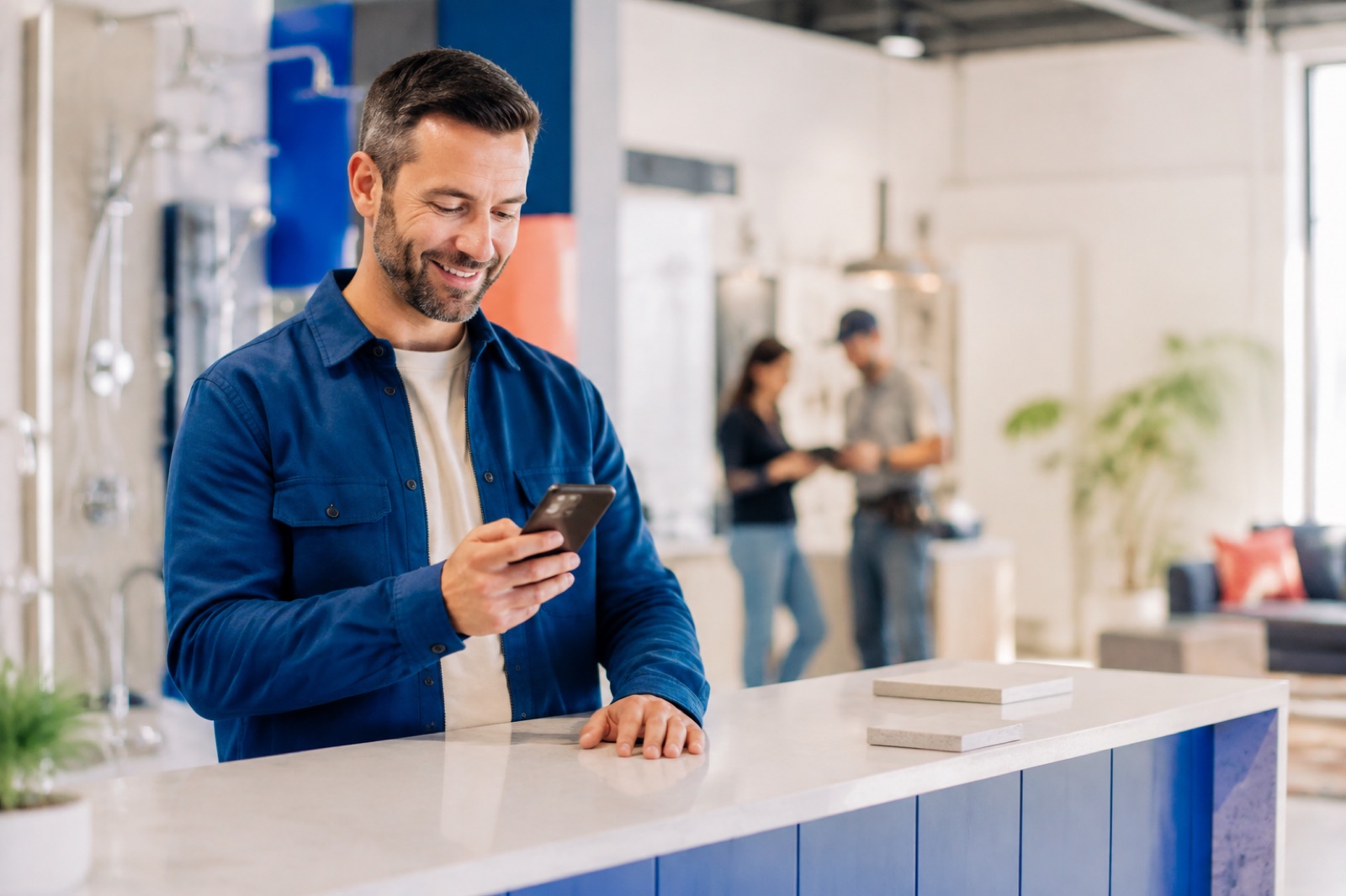 A business owner smiling while checking a customer message